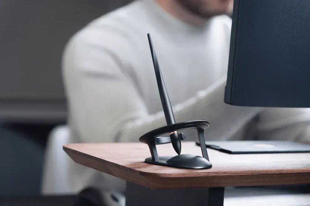 Hoverpen Interstellar hovering on a standing desk while its owner works at a computer